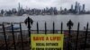 A sign in Hamilton Park in Weehawken, New Jersey, promotes social distancing April 3, 2020, with the New York City skyline in the background.