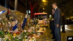 Le président Barack Obama , à droite, et français Francois Hollande déposent des fleurs au Bataclan , site de l'une des attaques terroristes à Paris.
