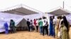 Voters line up prior to casting their vote in Senegal's legislative election, July 30, 2017, in Dakar. 