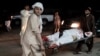 Afghan men carry a wounded man into a hospital following a car bomb explosion in Lashkargah, capital of Helmand province, Afghanistan, March 23, 2018. The attack prompted locals to stage an anti-war protest. 