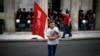 A refugee child holds a flag during a protest, called by the 'United against Rascism and the Fascist Threat' movement, demanding better conditions for refugees in the Greek camps, in front of the City Hal in Athens, June 9, 2016.