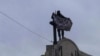FILE - In this image posted on Twitter by Syria's al-Qaida-linked Nusra Front March 28, 2015, a Nusra Front fighter holds up his group's flag in Idlib province, northern Syria.