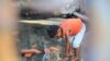 A girl is playing the flood water in front of Khoeun Sovat&rsquo;s house in Boeung Kak community in Phnom Penh, Cambodia, Nov. 13, 2014. (Nov Povleakhena/VOA Khmer)