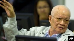 In this photo released by the Extraordinary Chambers in the Courts of Cambodia, Khieu Samphan, former Khmer Rouge head of state, gestures as he sits in the court room U.N.-backed war crimes tribunal in Phnom Penh, Cambodia, Thursday, Aug. 7, 2014. 