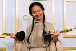 2021年4月25日，梳着两条印第安人小辫、身着爱马仕米色衣裙的赵婷在奥斯卡颁奖典礼上。(路透社)