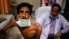 FILE - A doctor examines a tuberculosis patient in a government TB hospital in Allahabad, India, March 24, 2014. UNITAID has just launched a new multi-million dollar initiative to finance new treatments that can prevent the onset of full-blown tuberculosis.