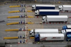 FILE - British soldiers test truck drivers for the coronavirus disease before entering the Port of Dover, Britain, Dec. 26, 2020.