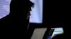 FILE - A man takes part in a hacking contest in Las Vegas, Nevada, July 29, 2017. The FBI and private cybersecurity firms have started teaming up to take down computer hackers.