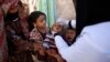 FILE - A boy receives a polio vaccination during a house-to-house polio immunization campaign in Sanaa, Yemen.
