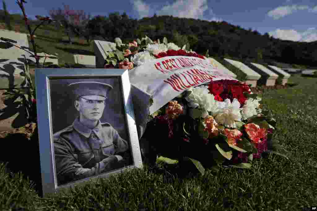The family of Australian Sgt. D. M. Williamson, killed May 3, 1915, placed tributes on his grave in Turkey's Shrapnel Valley cemetery, April 23, 2015. Nearly 700 Allied servicemen killed during the Gallipoli campaign are buried there.