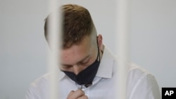 Finnegan Lee Elder touches a crucifix he has around his neck before a jury began deliberating the fates of Elder and his co-defendant Gabriel Natale-Hjorth, in Rome, May 5, 2021.