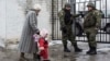 A woman accompanies her child to be evacuated from Avdiivka to Sviatohirsk, a town about 140 kilometers (88 miles) away and far from the conflict front line, in eastern Ukraine, Feb. 5, 2017. A sharp escalation in fighting between Ukrainian troops and Russia-backed rebels in the previous week had killed at least 33 people, centering on Avdiivka, a government-held town just north of rebel-controlled Donetsk.