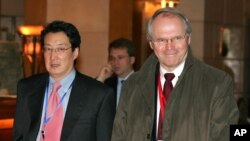 FILE - U.S. Assistant Secretary of State Christopher Hill, right, walks with Victor Cha, the U.S. National Security Council's director for Asian Affairs, before heading to six-party talks on North Korea's nuclear program in Beijing, March 22, 2007.