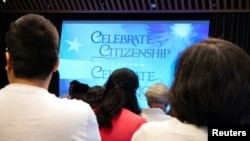 People attend a U.S. Citizenship and Immigration Services naturalization ceremony at the New York Public Library in New York on July 2, 2024.