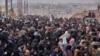 Syrian families, fleeing from various eastern districts of Aleppo, queue to get onto governmental buses, Nov. 29, 2016, in the government-held eastern neighborhood of Jabal Badro, before heading to government-controlled western Aleppo. The crisis in Syria is currently the United Nations' biggest humanitarian concern.