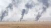 FILE - Smoke rises in the aftermath of clashes with Islamic State militants on the southeast of Mosul, Iraq, Aug. 14, 2016.