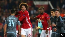 Marouane Fellaini de Manchester United tient le dos de son co-équipier Eric Bailly lors du match retour de demi-finale d’Europa League contre Celta Vigo au stade Old Trafford à Manchester, Angleterre, 11 mai 2017.