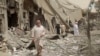 This undated frame grab from video posted online May 29, 2017, by the Aamaq News Agency, a media arm of the Islamic State group, shows people inspecting damage from airstrikes and artillery shelling in the northern Syrian city of Raqqa, the de facto capital of IS.