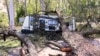 A fallen tree lays across a camping trailer near the Gold Coast, Australia, Dec. 26, 2023. 