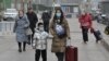 People walk on a street in Beijing on Jan. 17, 2024. China's population decline accelerated in 2023, official data showed, extending a downward streak after more than six decades of growth as the country battles a looming demographic crisis. 