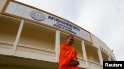 FILE - A Buddhist monk walks in front of a court room at the Extraordinary Chambers in the Courts of Cambodia (ECCC), on the outskirt of Phnom Penh October 16, 2013. 