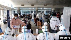 海外抵達北京的旅客在北京國際會展中心接受登記檢測與分流。 （2020年3月18日）
