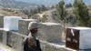 FILE - A Pakistani soldier stands guard at a newly erected fence between Pakistan and Afghanistan, at Angore Adda, Pakistan, Oct. 18, 2017.