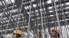 Laborers work at a flyover construction site in Mumbai, 29 Dec 2010
