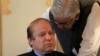 FILE - Former Pakistani Prime Minister Nawaz Sharif speaks with an official during a meeting in Islamabad, Aug. 9, 2017. 