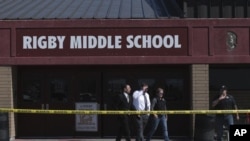 Officers leave Rigby Middle School after a shooting in Rigby, Idaho on Thursday, May 6, 2021. Authorities say a shooting at the eastern Idaho middle school has injured two students and a custodian, and a male student has been taken into custody. (John Roa