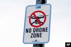 A sign that prohibits drone flights in the area is posted adjacent to Logan International Airport, May 18, 2018, in Boston.