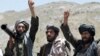 FILE - In this May 27, 2016, photo, Taliban fighters react to a speech by their senior leader in the Shindand district of Herat province, Afghanistan.