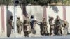 Afghan security personnel rescue a man from the Shamshad TV compound after an attack in Kabul, Nov. 7, 2017.