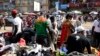 FILE - Pedestrians shop for clothes at Mokolo Market in Yaounde, Cameroon, Oct. 11, 2018. 