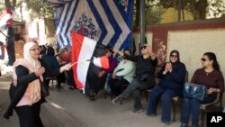 Des électeurs se préparent à aller voter au Caire, le 26 mars 2018. 