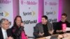 T-Mobile and Sprint executives enjoy a laugh as they accounce the two companies' planned merger April 29, 2018, in New York.