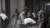 Men store bags of flour unloaded from a Red Crescent aid convoy in the rebel held besieged town of Jesreen, in the eastern Damascus suburb of Ghouta, Syria, March 7, 2016. 