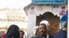Sally al-Sahabi, 12, and her father enter the police station, hoping that having her husband arrested will pressure him into granting her a divorce
