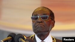 President Robert Mugabe waits to address crowds gathered for Zimbabwe's Heroes Day commemorations in Harare, August 10, 2015.