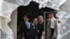 FILE - Israel's President Isaac Herzog, center left, and German President Frank-Walter Steinmeier, center right, visit Kibbutz Beeri in southern Israel, Nov. 27, 2023.