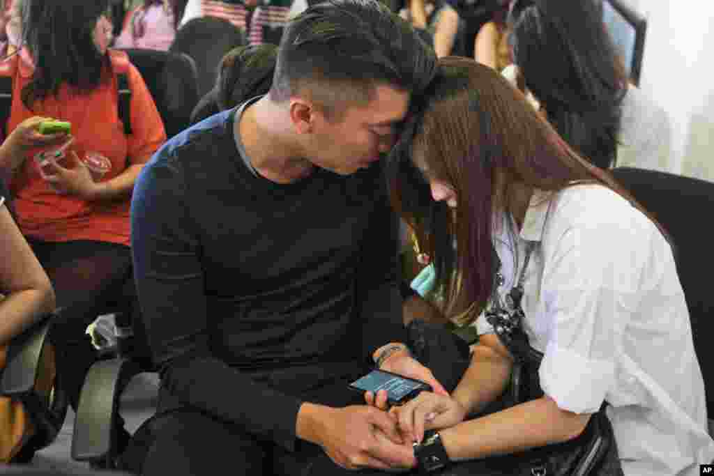 Relatives of the passengers of AirAsia flight QZ8501 comfort each other at Juanda International Airport in Surabaya, East Java, Indonesia, Dec. 28, 2014.