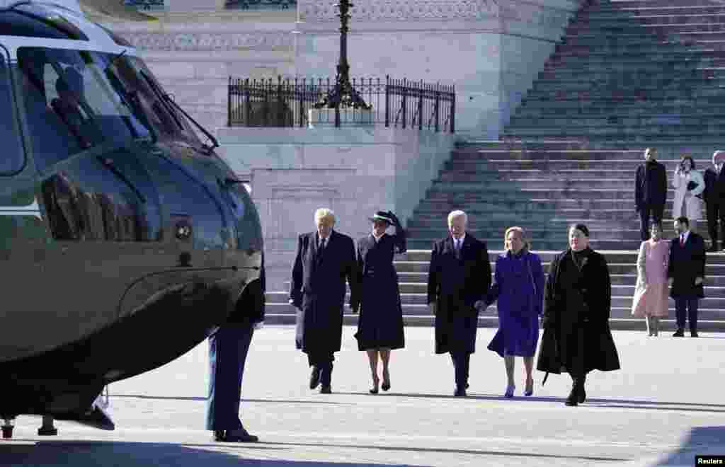 ប្រធានាធិបតី Donald Trump និងលោកស្រីទី១ Melania Trump ដើរពីវិមានសភាអាមេរិកជាមួយអតីតប្រធានាធិបតីលោក Joe Biden និងអតីតលោកស្រីទី១ lady Jill Bidenនៅពេលដែលពួកគាត់នឹងជិះឧទ្ធម្ភាគចក្រ Marine One ក្នុងថ្ងៃស្បថចូលកាន់តំណែងរបស់លោក Trump នៅរដ្ឋធានីវ៉ាស៊ីនតោនកាលពីថ្ងៃទី២០ មករា ឆ្នាំ២០២៥។