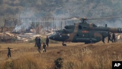 FILE - Chinese and Pakistani troops take part in a joint war exercie in Jhelum, Pakistan, Nov. 24, 2011.