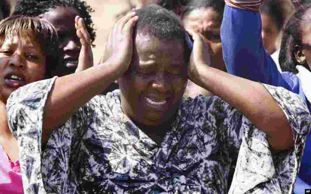 An unidentified woman cries as she protests against the police opening fire and killing striking mine workers a day earlier at the Lonmin Platinum Mine near Rustenburg, South Africa, August 17, 2012.