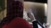 FILE - A Palestinian woman smokes a water pipe at a cafe in Gaza City, July 18, 2010. 