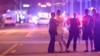 FILE - Police direct family members away from a multiple shooting at a nightclub in Orlando, Florida, June 12, 2016. 