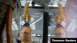 A Thai traditional giant statue wears a protective mask at Suvarnabhumi Airport in Bangkok