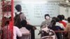 A student is reading and translating English words in a pay-per-lesson English class on the southeast corner of Baktouk High School in Phnom Penh, Cambodia, at around 6 PM on July 17, 2015. (Sou Pisen/VOA Khmer)