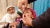 FILE - A child receives a polio vaccination during an anti-polio campaign on the outskirts of Jalalabad, March 16, 2015.