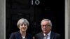 FILE - Britain's Prime Minister Theresa May welcomes Head of the European Commission, President Jean-Claude Juncker to Downing Street in London, April 26, 2017. 